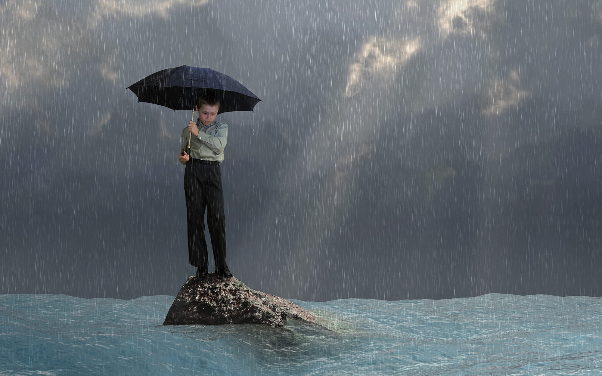 Child standing with umbrella
